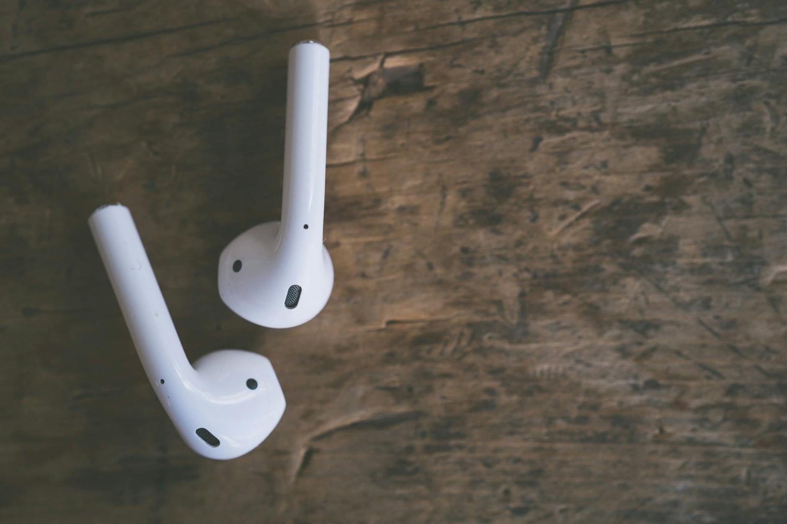airpods on a wooden surface