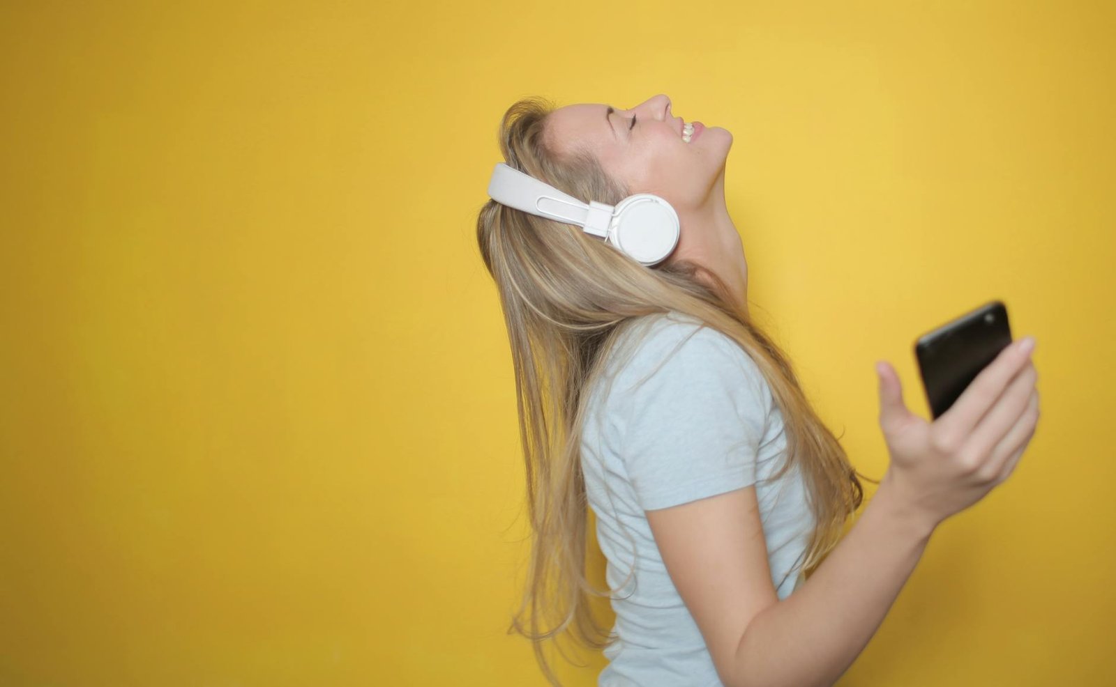 photo of woman listening to music